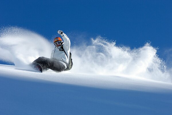 Snowboarder descends from the mountain winter a lot of snow