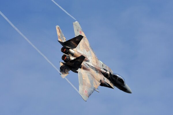 Fighter jet on the background of the sky flying down