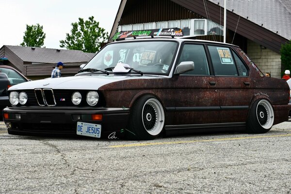 Old rusty bmw car in the parking lot