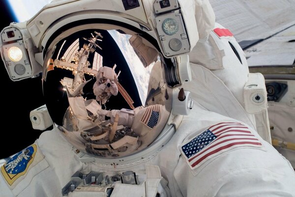 Reflection in the spacesuit of an American astronaut