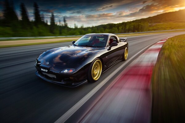 The picture goes mazda, rx7 on the road