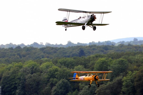 Two planes in the sky over the taiga