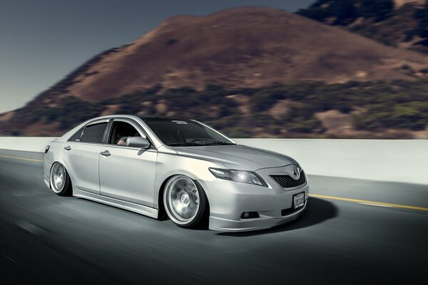 Gray Toyota car in motion on a beautiful background of nature