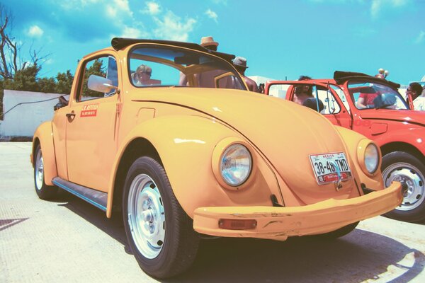 A vintage, yellow VW beetle car