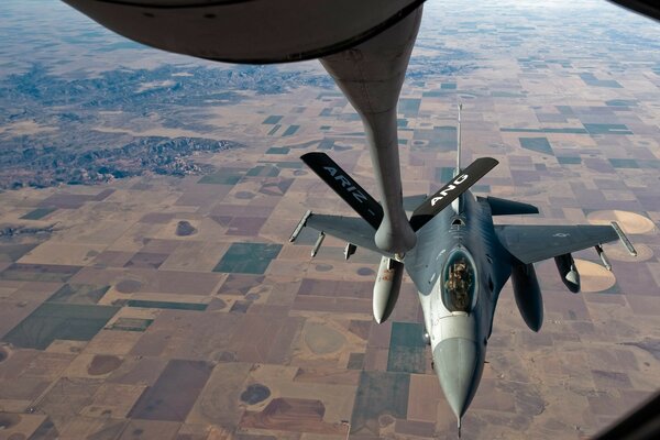 Flying f-16 over the ground. 120 fighter company