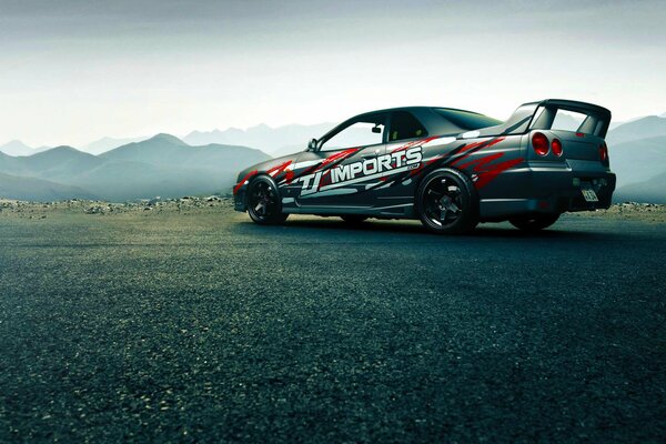 Racing Nissan on the background of mountains