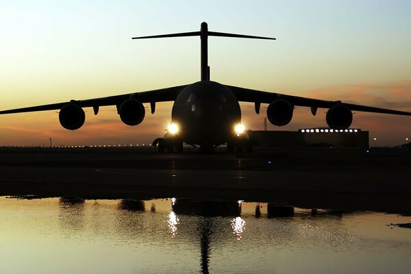 Militärflugzeug landet in der Dämmerung