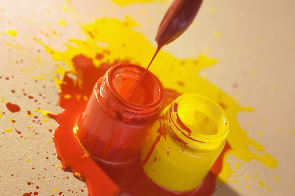 Containers of yellow and orange paint