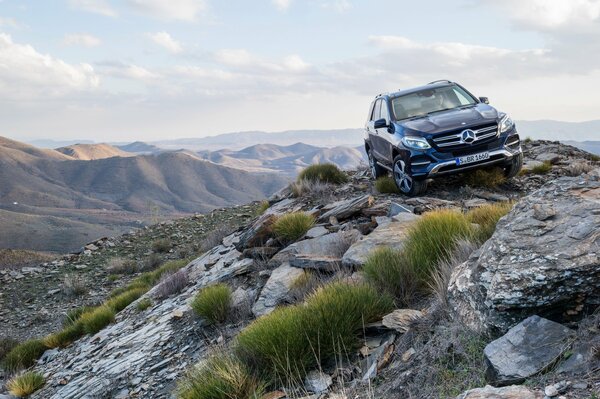 A chic Mercedes Benz on the background of mountain ranges