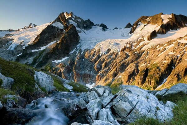 Snow-capped mountain peaks in the light of the sun