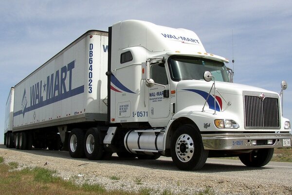 A white road train is on the road