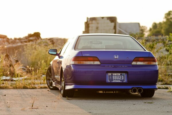 Blue Honda in tuning with a beautiful view