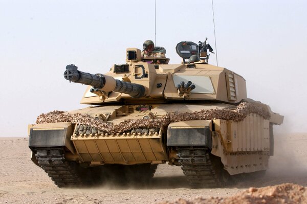 A man on a brown tank in the desert