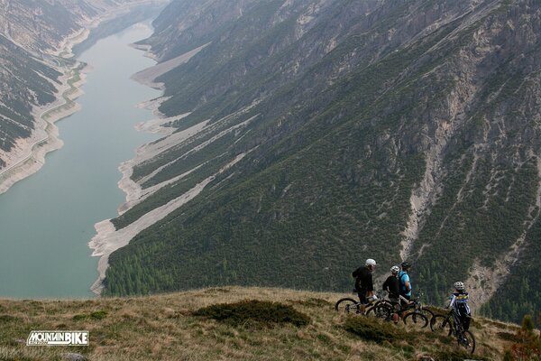 Cyclists on the slope beautiful nature long river