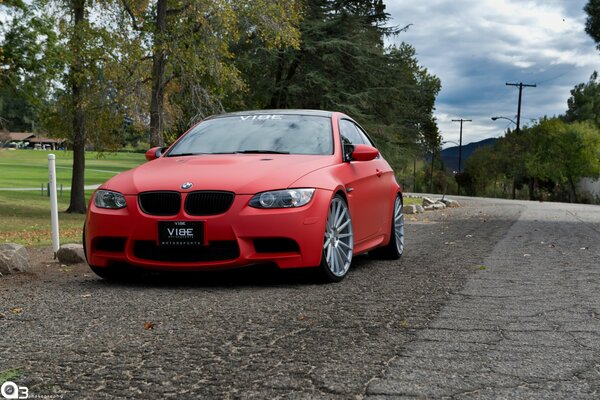 Red matte bmw m3 on the road