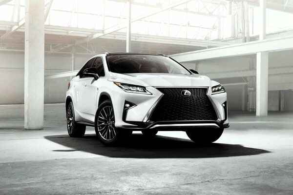 The handsome Lexus is parked in a hangar with a transparent roof