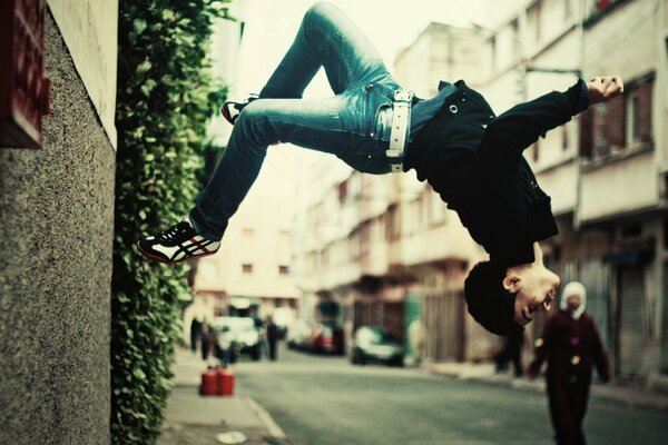 The guy does a somersault on the street