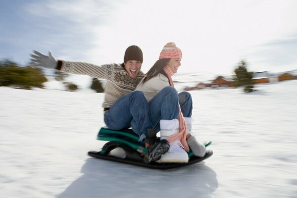 A guy and a girl are rolling down the mountain on a minibus