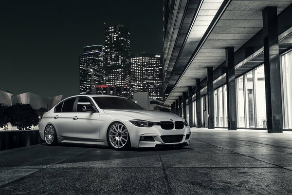 White BMW in the lights of the night city