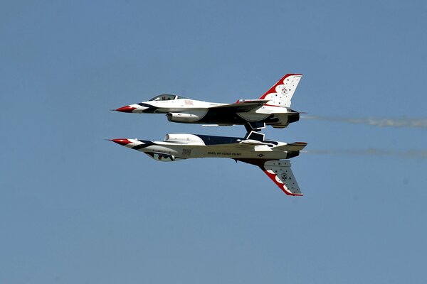 An aerobatic group of fighters demonstrates a mirror flight