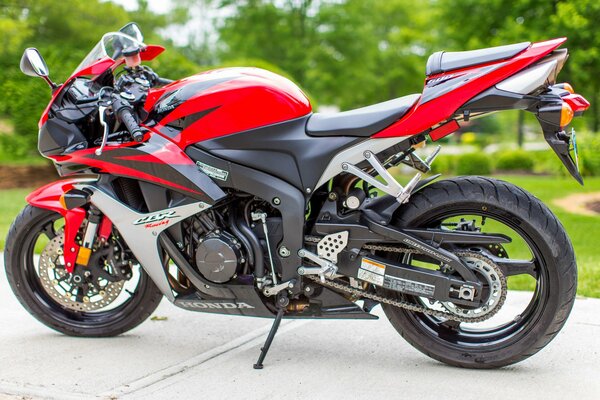 A red sports motorcycle stands on the running boards