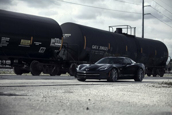 Chevrolet Corvette sullo sfondo di cisterne