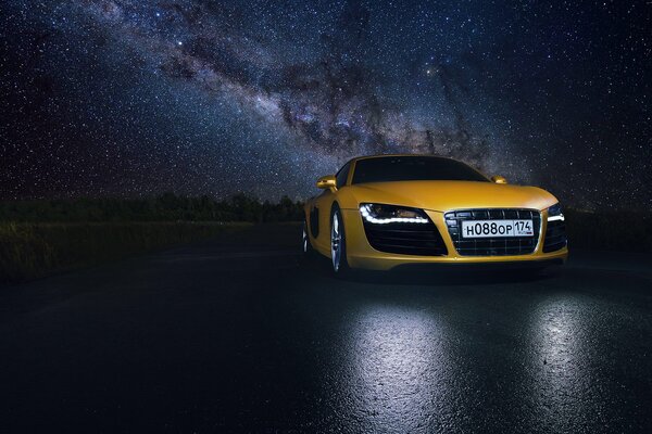 Yellow supercar on the background of the night sky