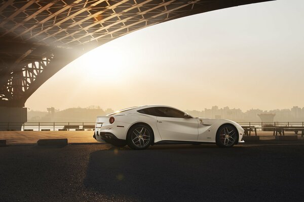 White Ferrari supercar under the bridge