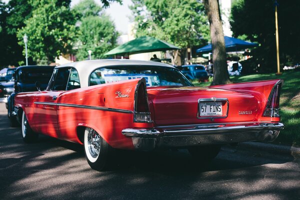 A picture of a classic red chrysler windsor 1957-1958 car