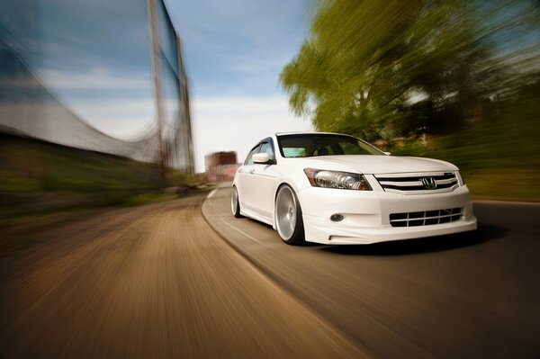 Honda blanco en movimiento en una curva