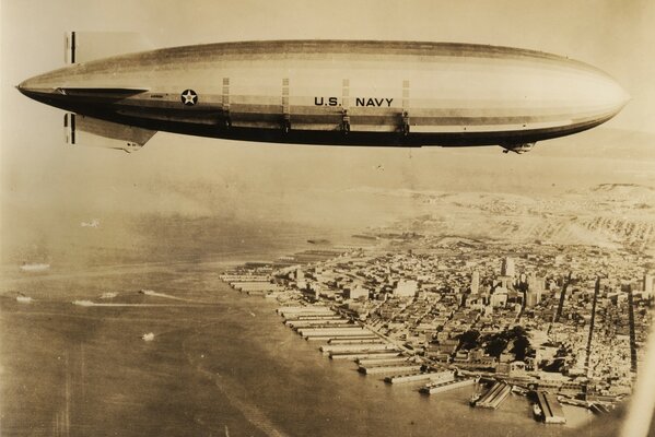 The airship flies over the city in the old days