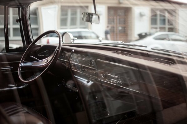 Old car salon with steering wheel and instruments