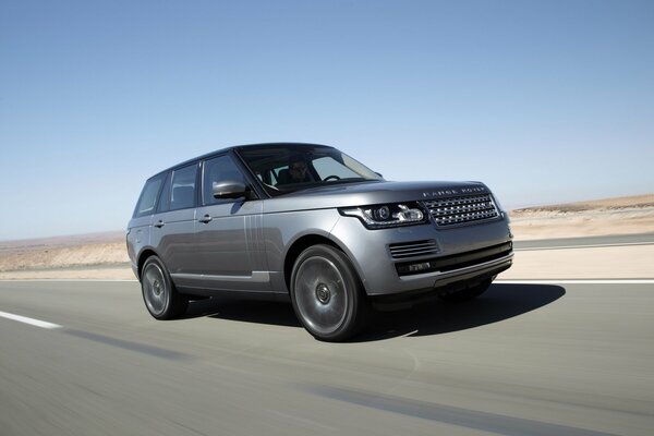 Range rover fast driving on the highway in the desert