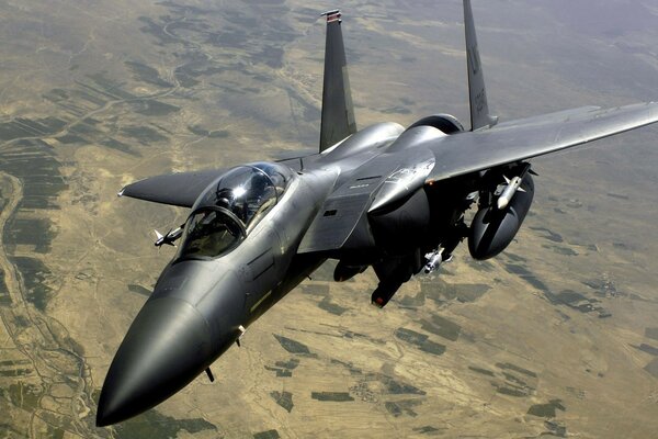 F-15e military aircraft in the sky against the background of the earth