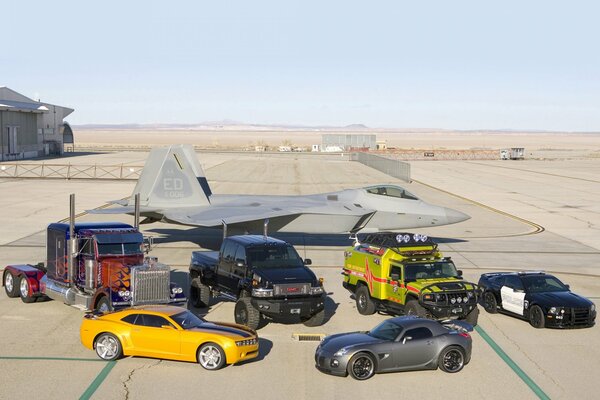 Vehicles military equipment in the parking lot of the airfield . All models together on the horizon