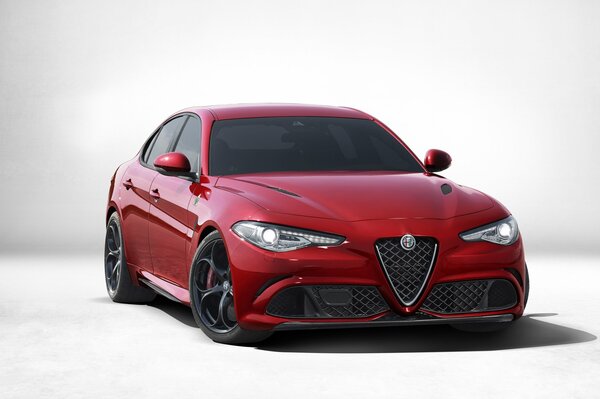 Alfaromeo Giulia rojo sobre fondo gris