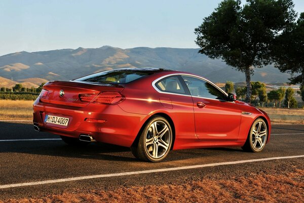 Red BMW coupe on the road