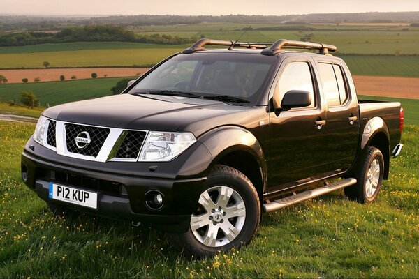 Black nissan, navara on the background of the landscape