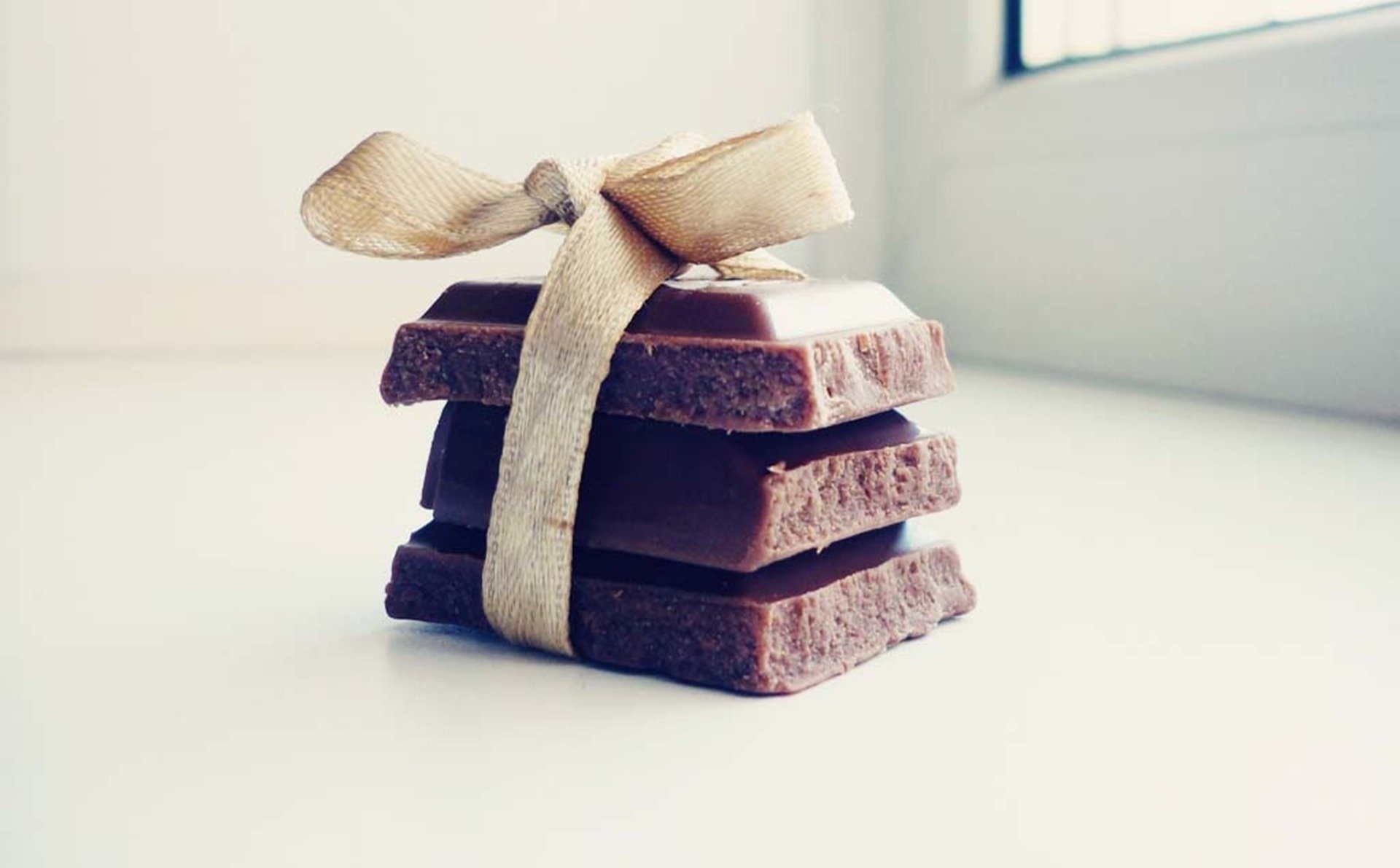 macro chocolate macro bow light background gift sweet tile chocolate sweets sweet gift creative