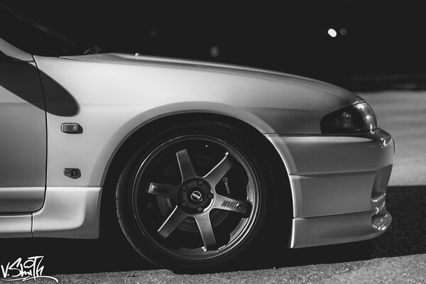 Black and white photo of a Nissan car