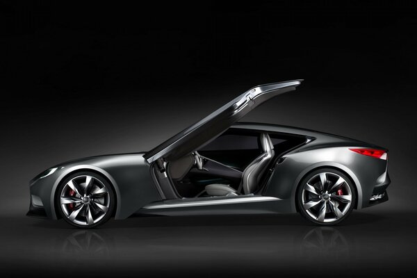 A chic black concept car with an open door on a black background