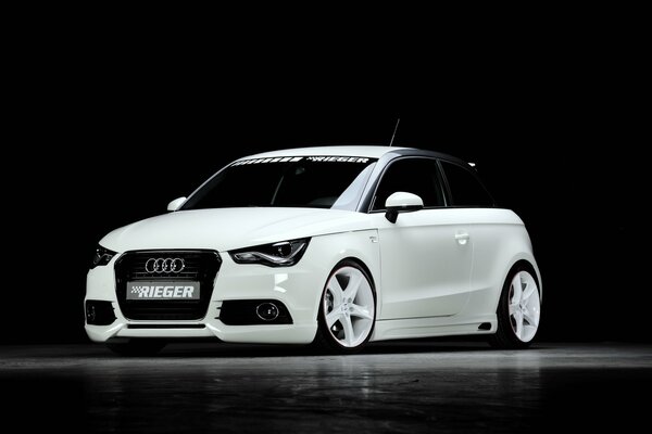 White tuned Audi on a black background