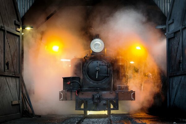 The train leaves the gloomy foggy tunnel