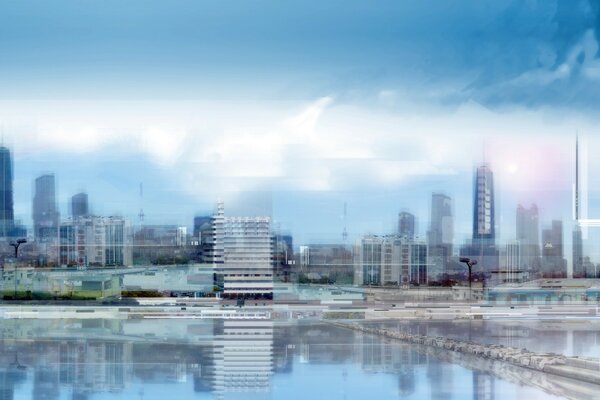 A dim photo in blue tones of skyscrapers overlooking the lake