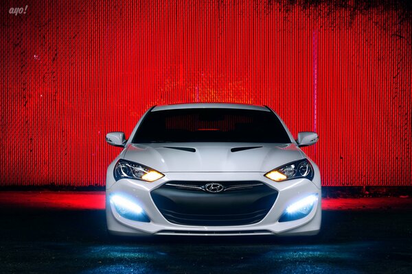 White luxury hyundai genesis on a red background