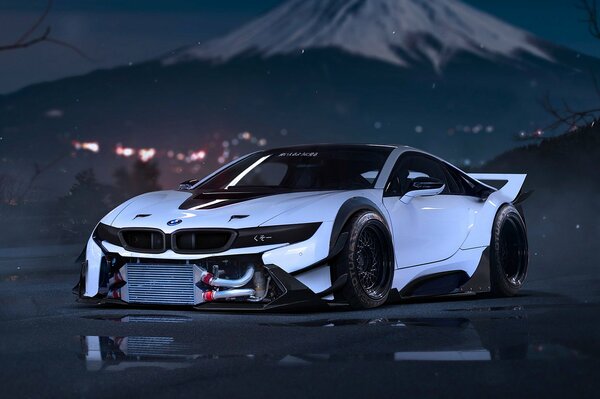 Gorgeous white BMW on the background of a snow-covered mountain