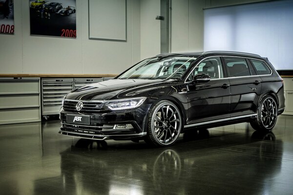 A black Volkswagen stands on a black floor