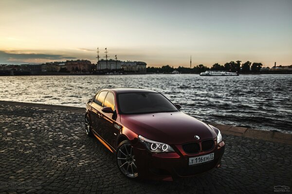 The new car is red against the background of water