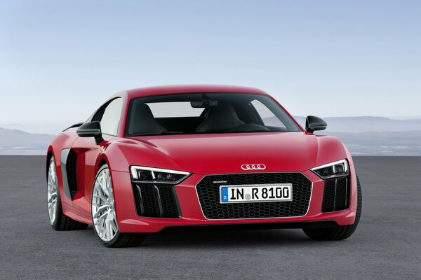 Red Audi r8 on the background of the sea