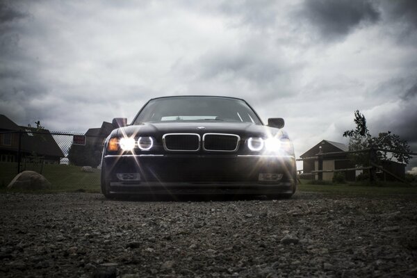 A tuned black boomer shines its headlights forward